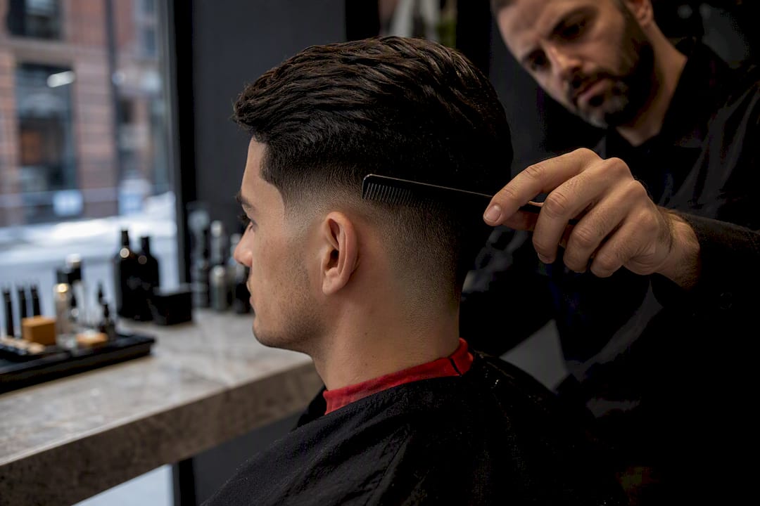 Barber comparing temple fade and taper areas