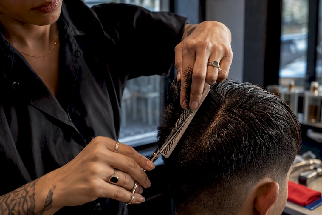 Barber performing scissor over comb technique