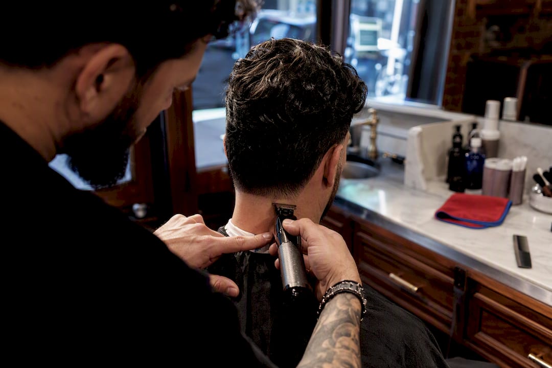 Barber shaping a clean men’s neckline