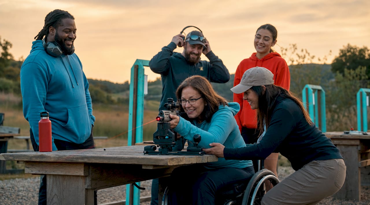 Adaptive shooting station with participant and instructor outdoors
