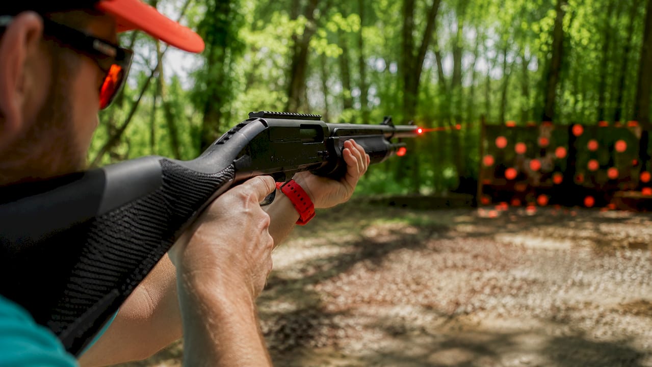 Close-up of hands holding laser clay shotgun