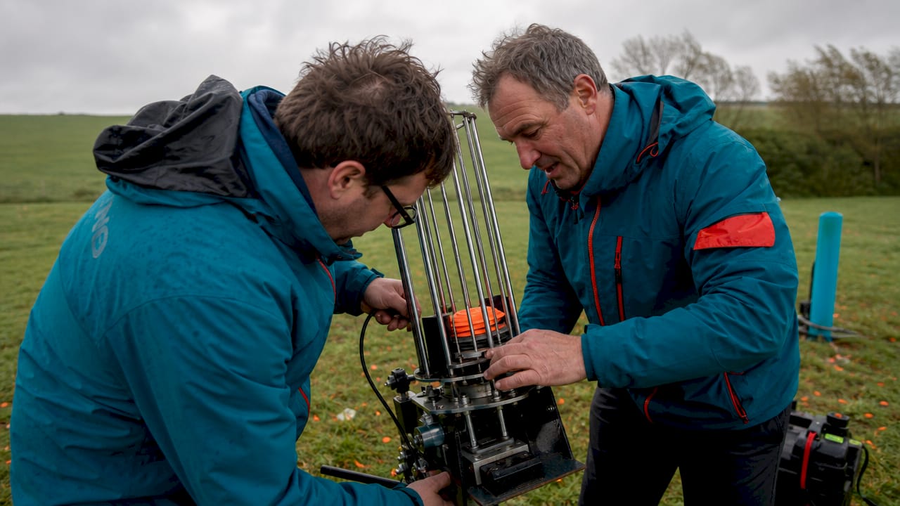 Participants adjusting launchers on windy outdoor clay shooting range