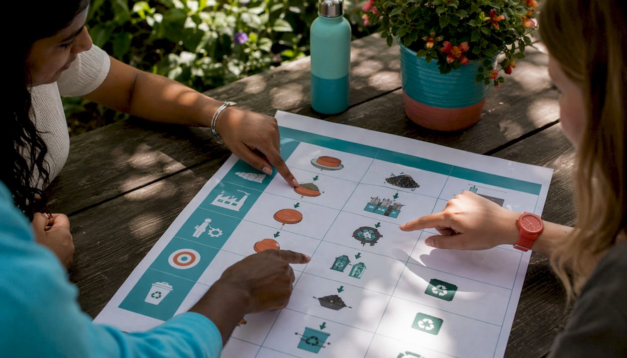Hands examining environmental impact chart of shooting methods