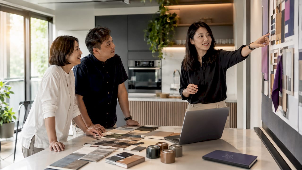 Interior designer consulting Singapore couple in living room