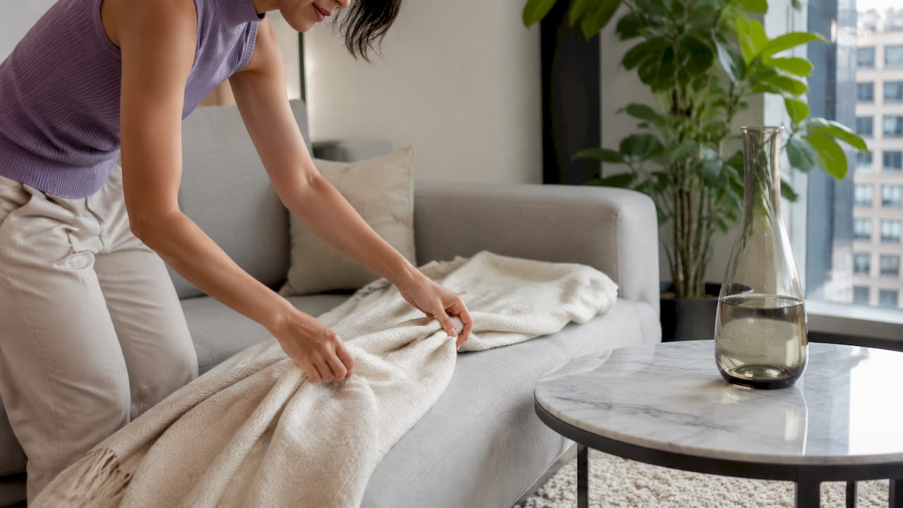Hand layering textiles in transitional interior corner