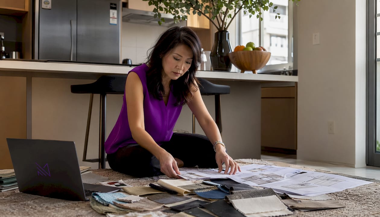 Singaporean woman reviewing HDB living room layout plans