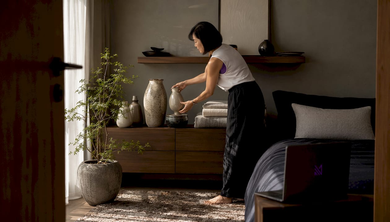Singaporean woman arranging Japandi decor