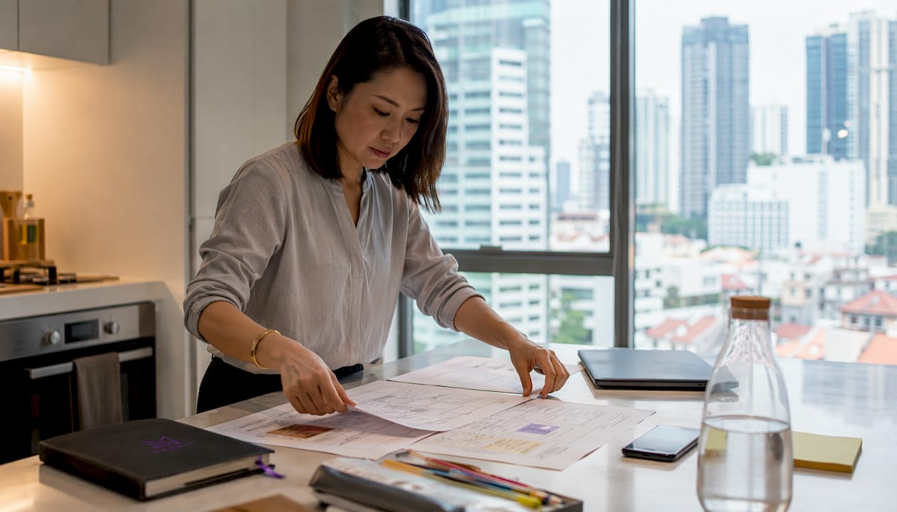 Singapore Asian woman reviewing marketing briefs in home office
