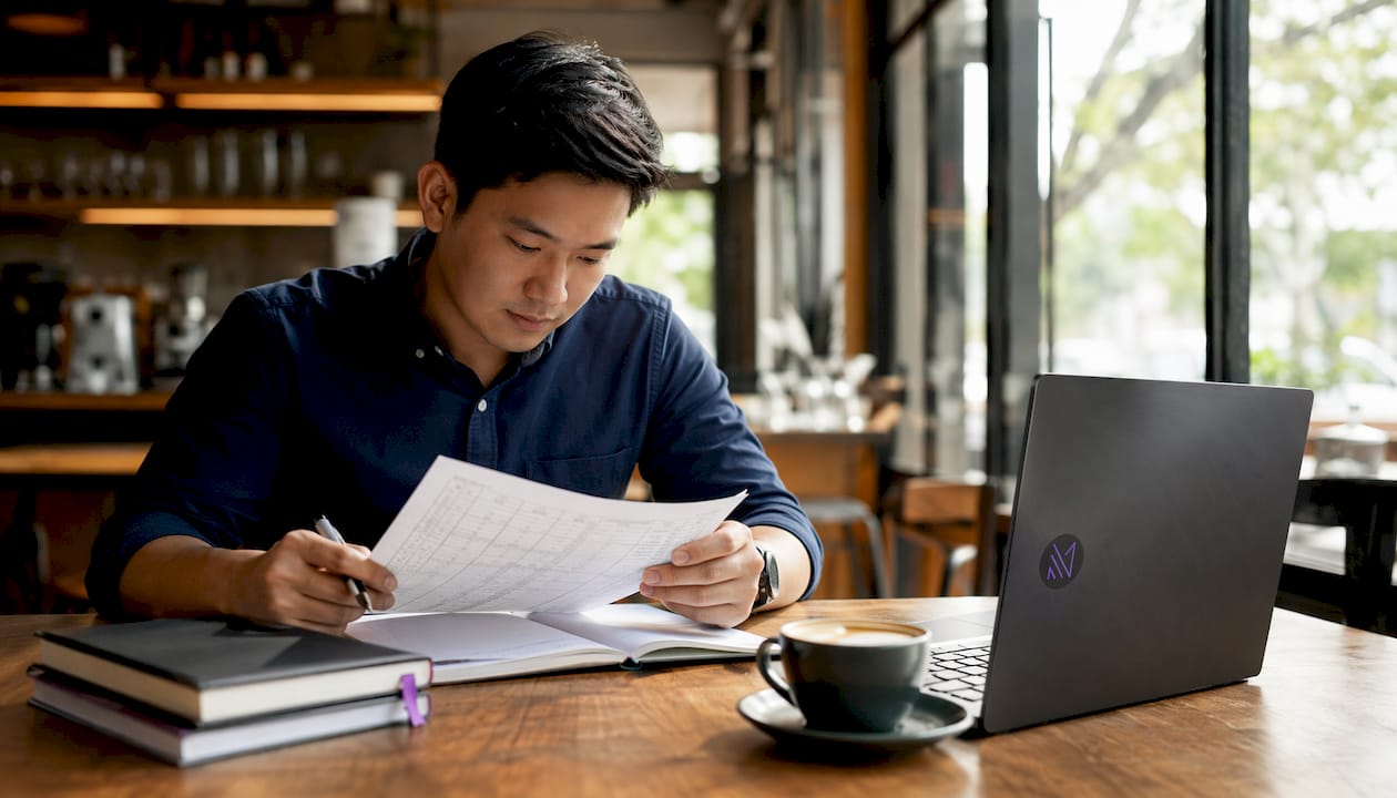 Singaporean HVAC engineer reviewing BTU charts