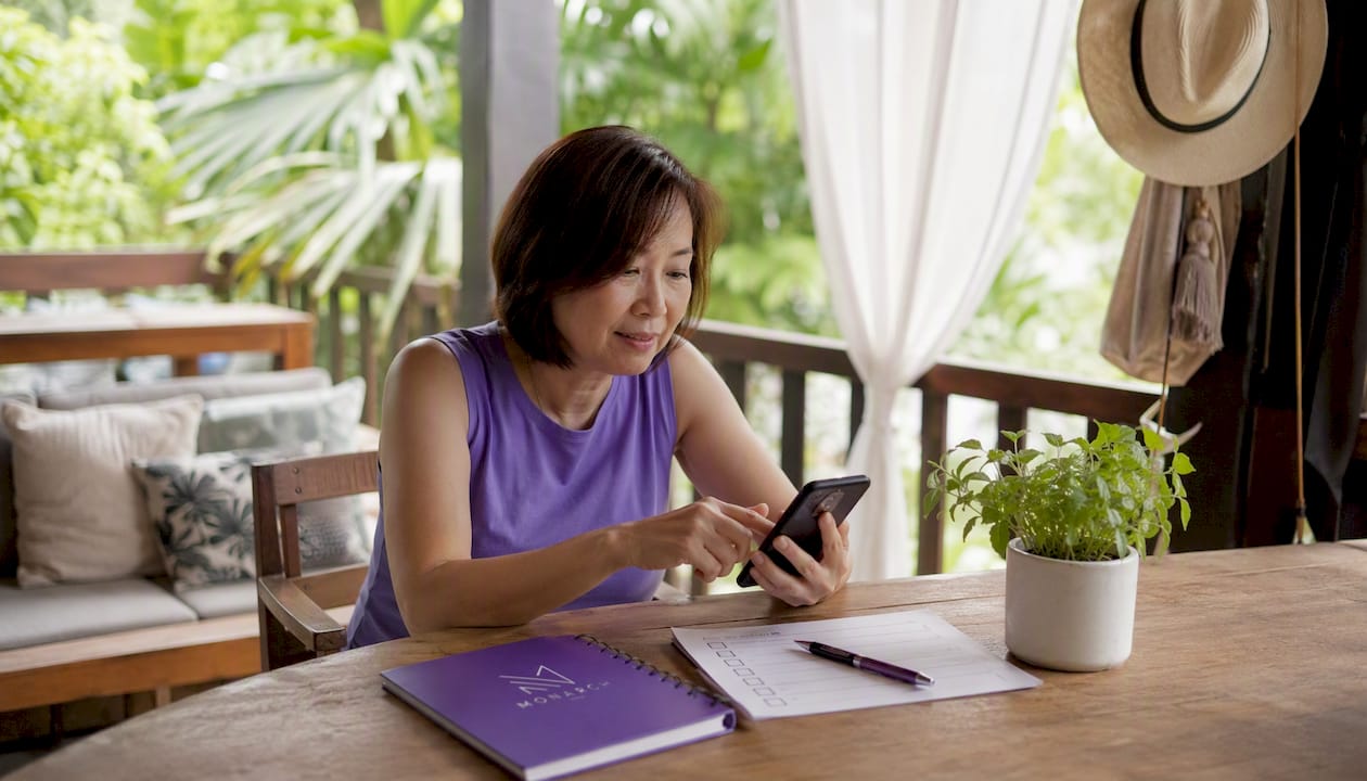 Singapore woman researching plumbers on smartphone