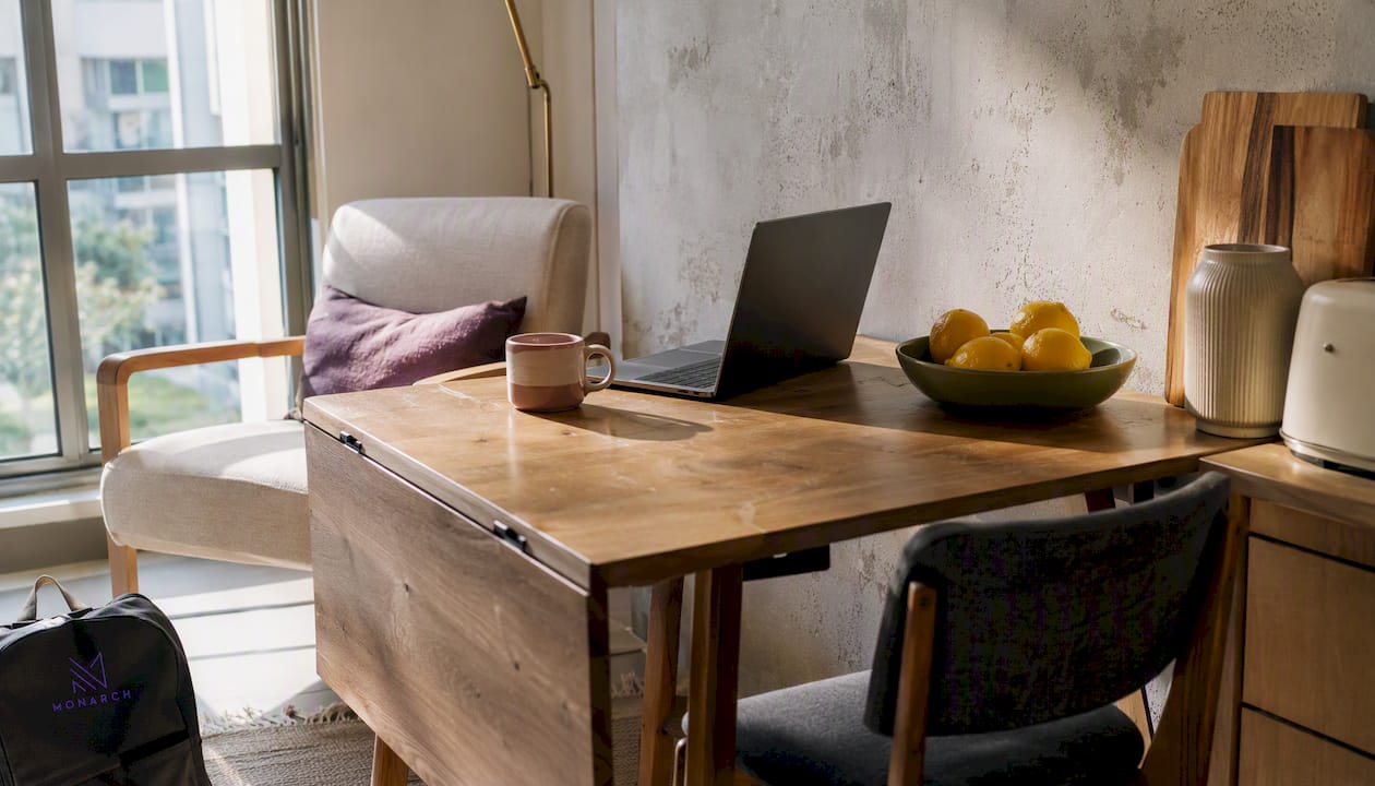Narrow drop-leaf dining table with stools in kitchen nook