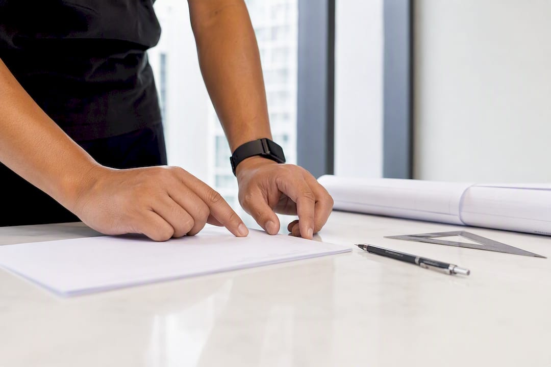 Craftsman’s hands inspecting contract papers
