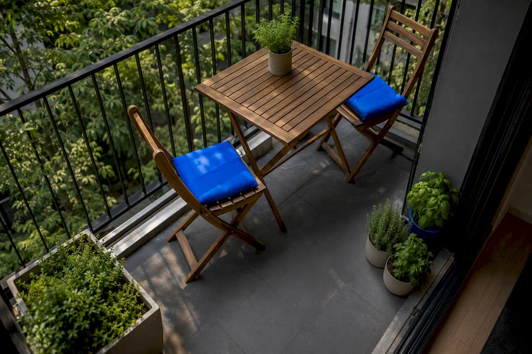 Foldable teak bistro furniture on small balcony