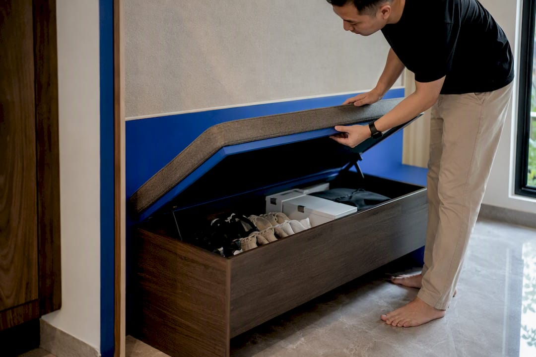 Bench storage compartment opened to reveal shoes