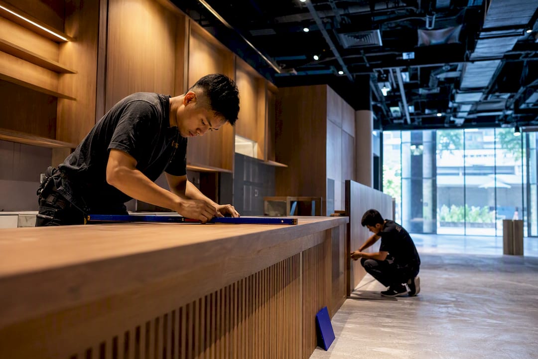 Singaporean carpenters installing cafe millwork