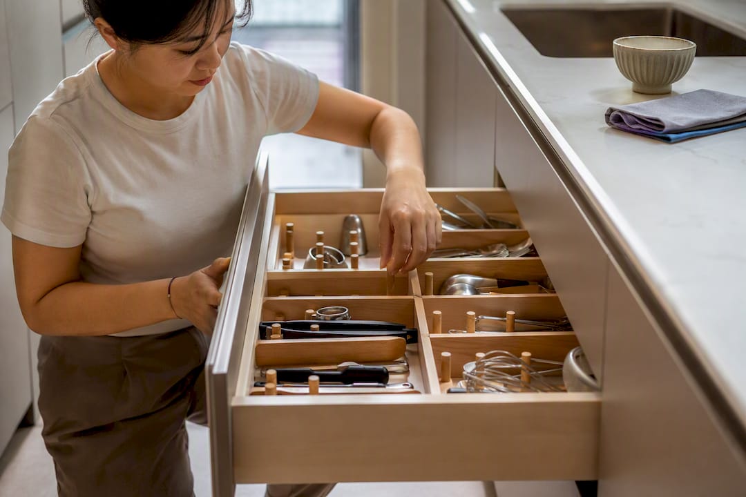 Homeowner opening organized deep kitchen drawer