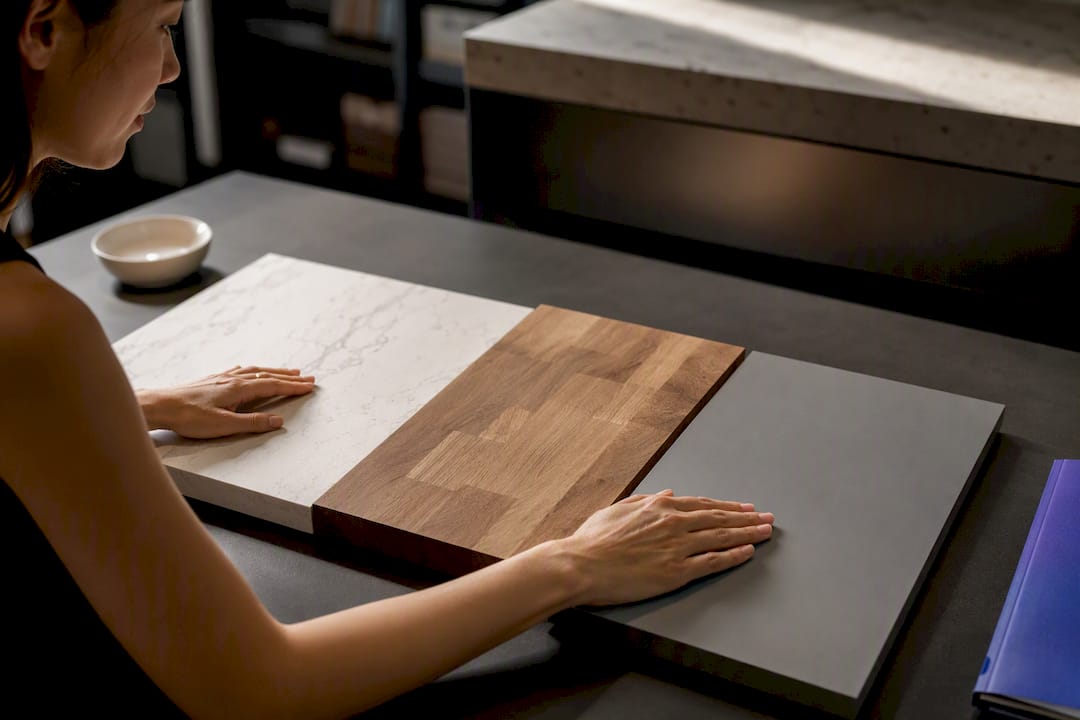Asian homeowner comparing kitchen material samples