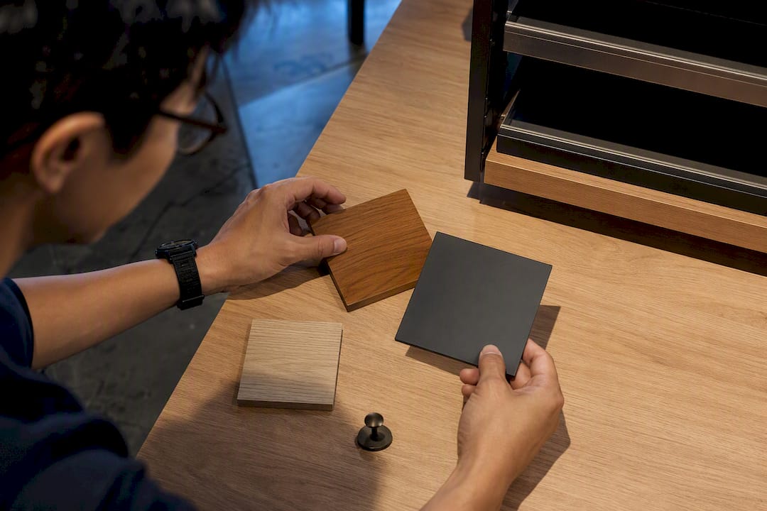 Asian designer comparing retail finish swatches