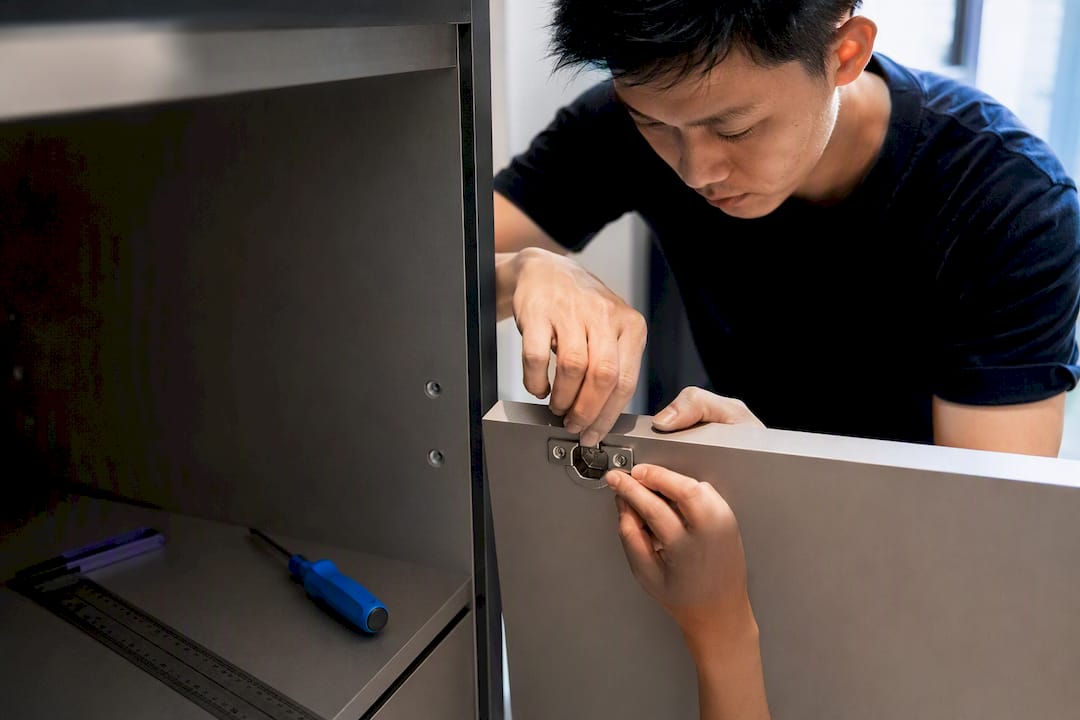 Carpenter aligning soft-close cabinet hinge
