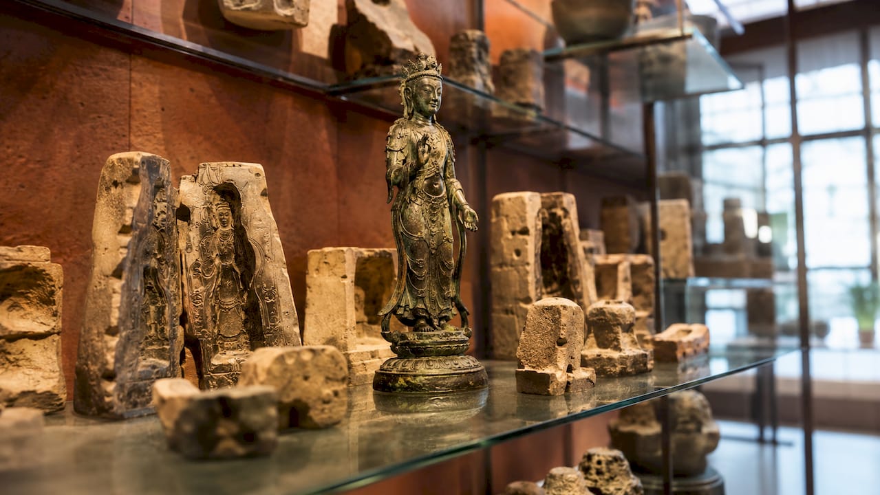 Museum exhibit of Asian bronze casting molds and bronzes
