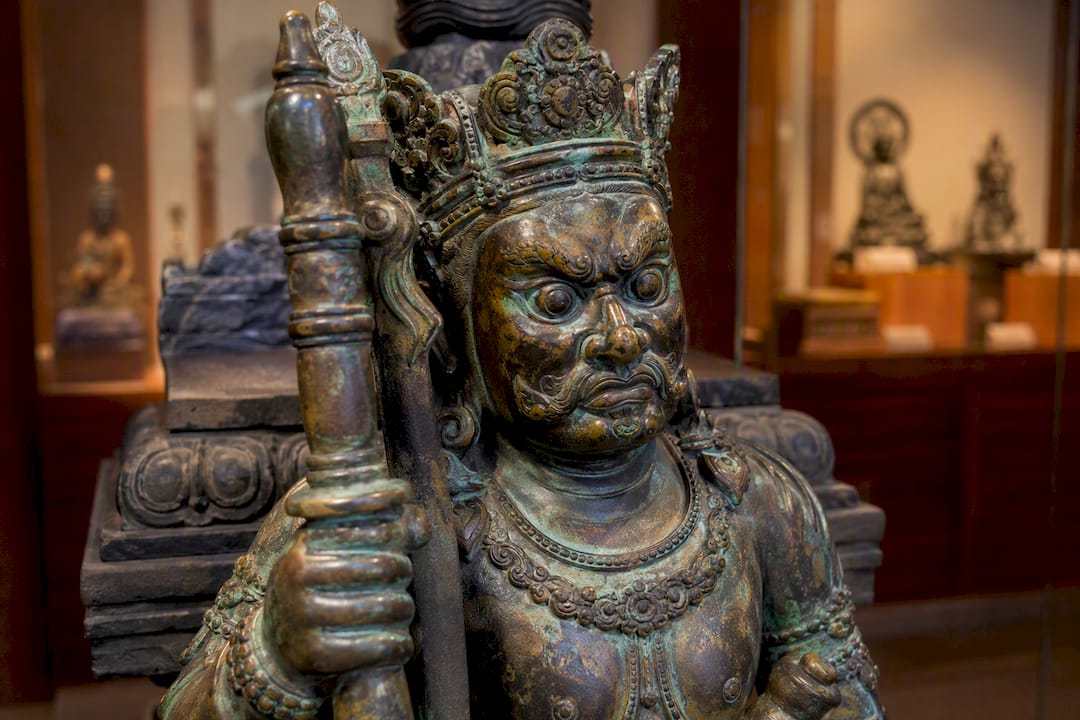 Close-up of bronze dvarapala sculpture detail
