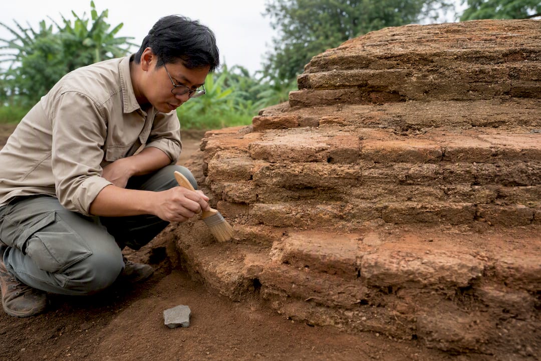 Archaeologist examining Batujaya brick stupa