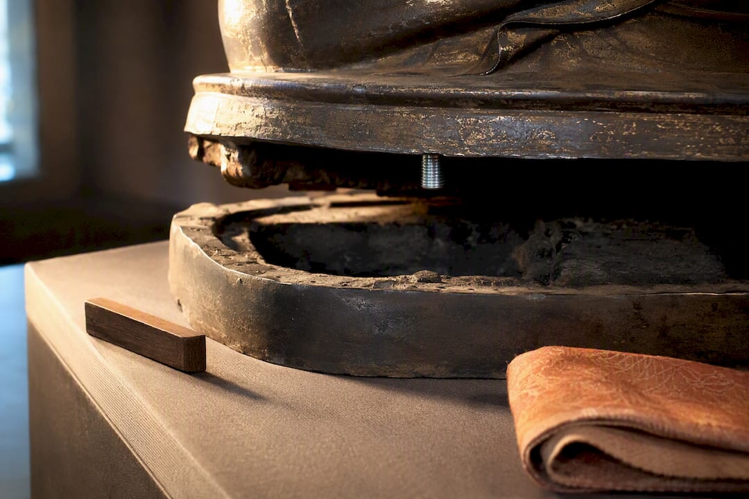 Opened bronze statue base showing interior