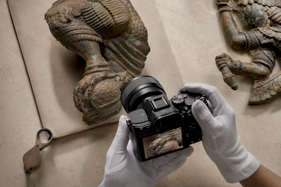 Collector photographing Garuda iconographic details