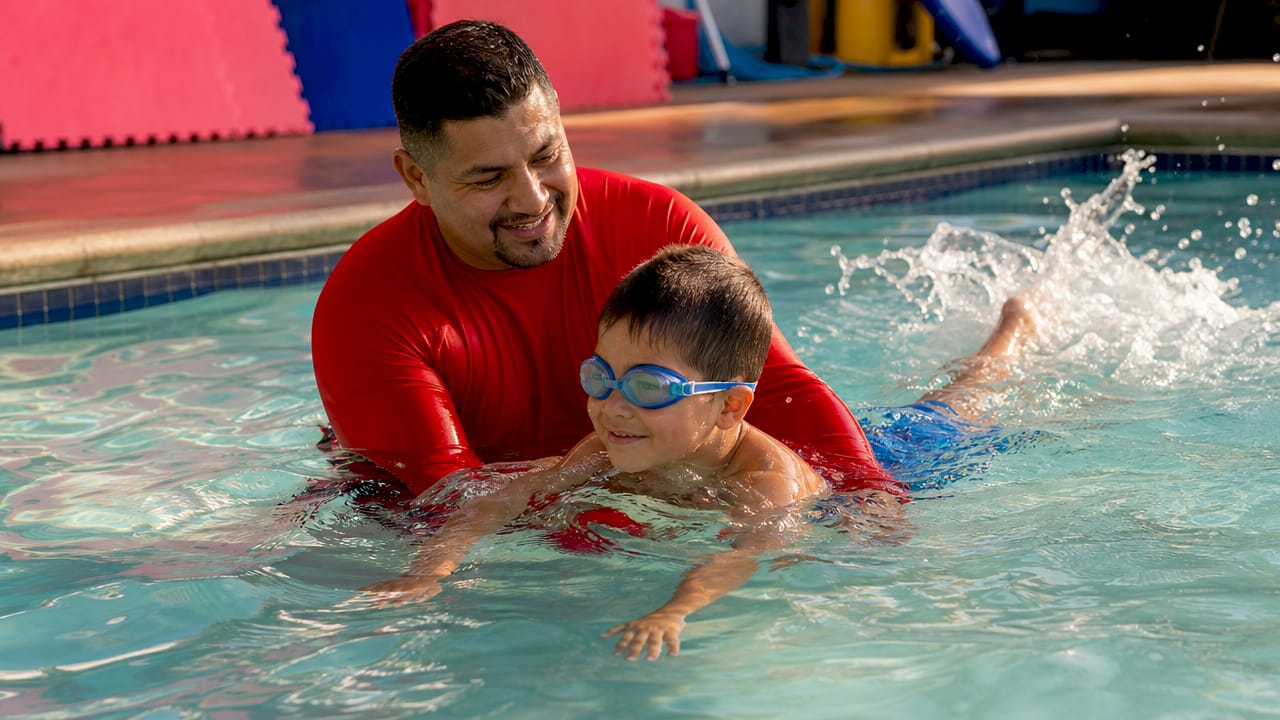 Swim instructor aiding child practicing kicking technique