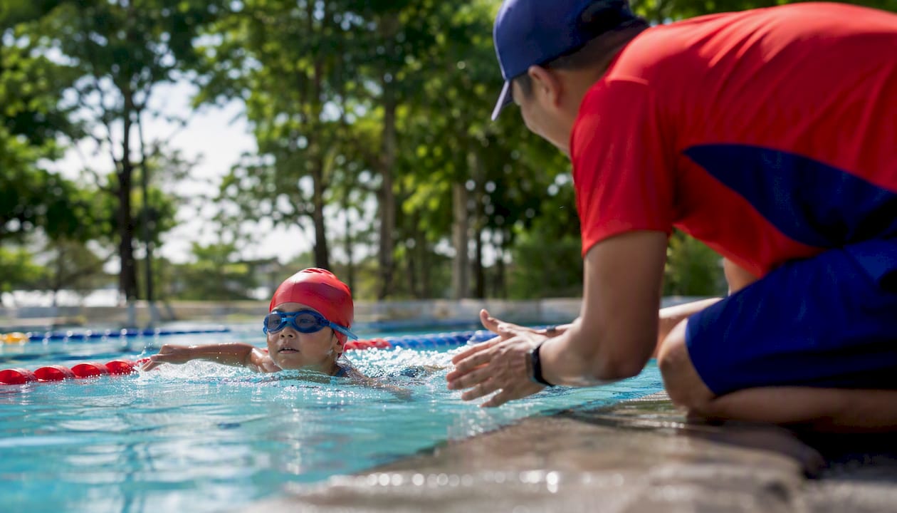Child swimming face-down in pool