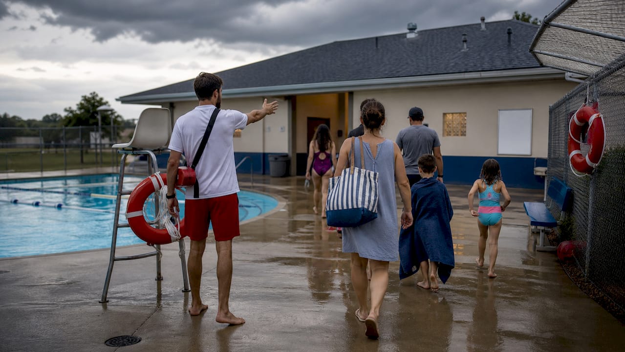 Lifeguard leading pool evacuation during storm