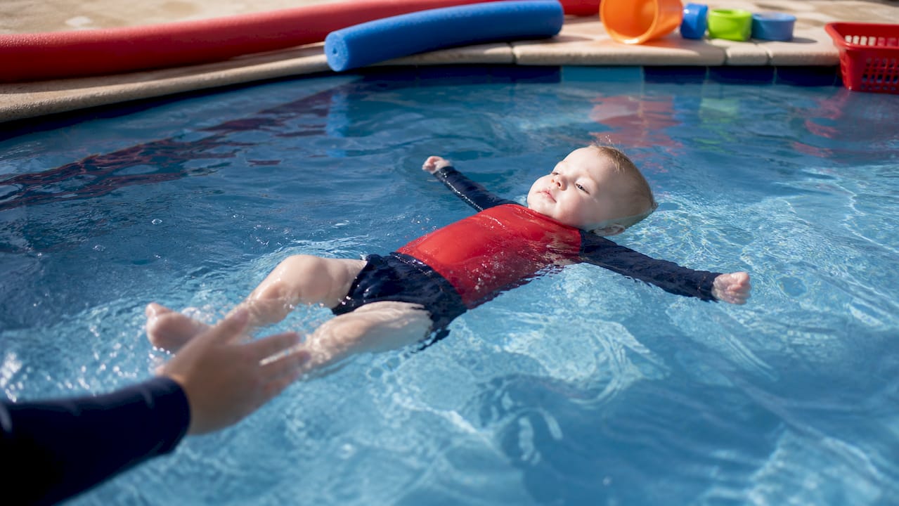 Toddler floating independently in teaching pool