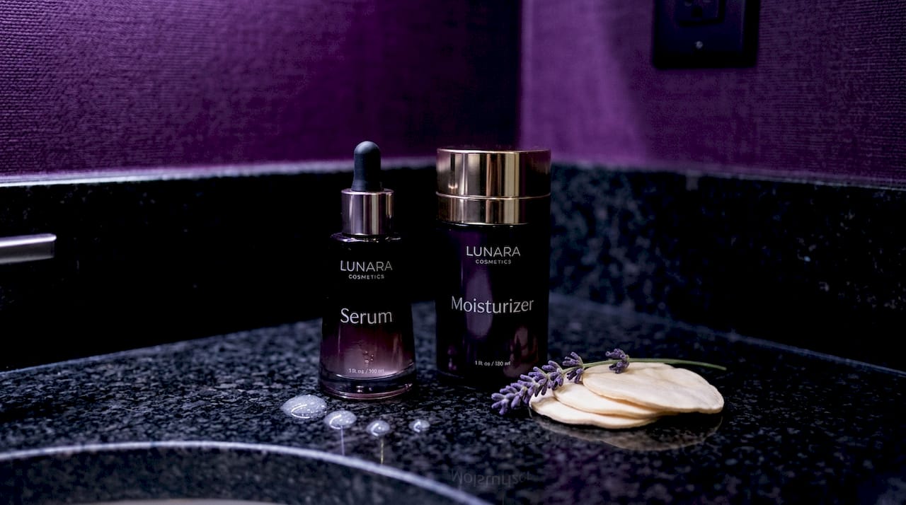 Close-up of serum and moisturizer bottles on countertop