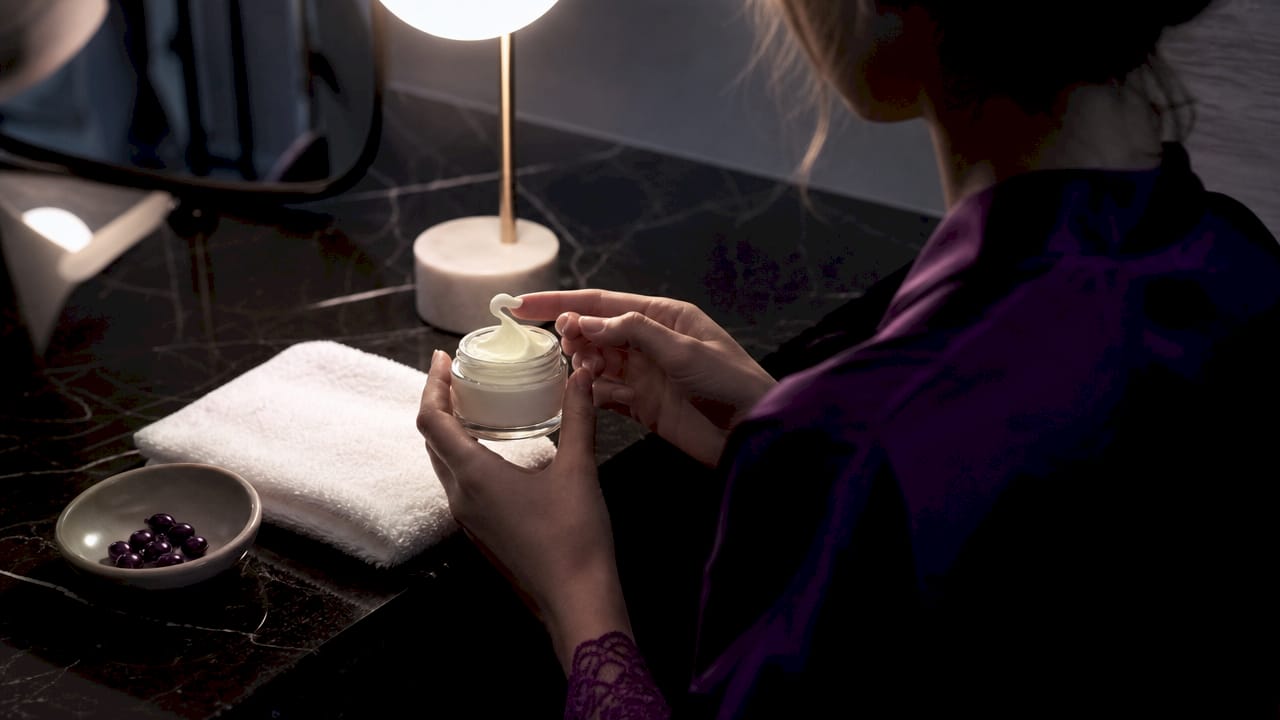 Hands holding comfort cream jar with natural ingredients
