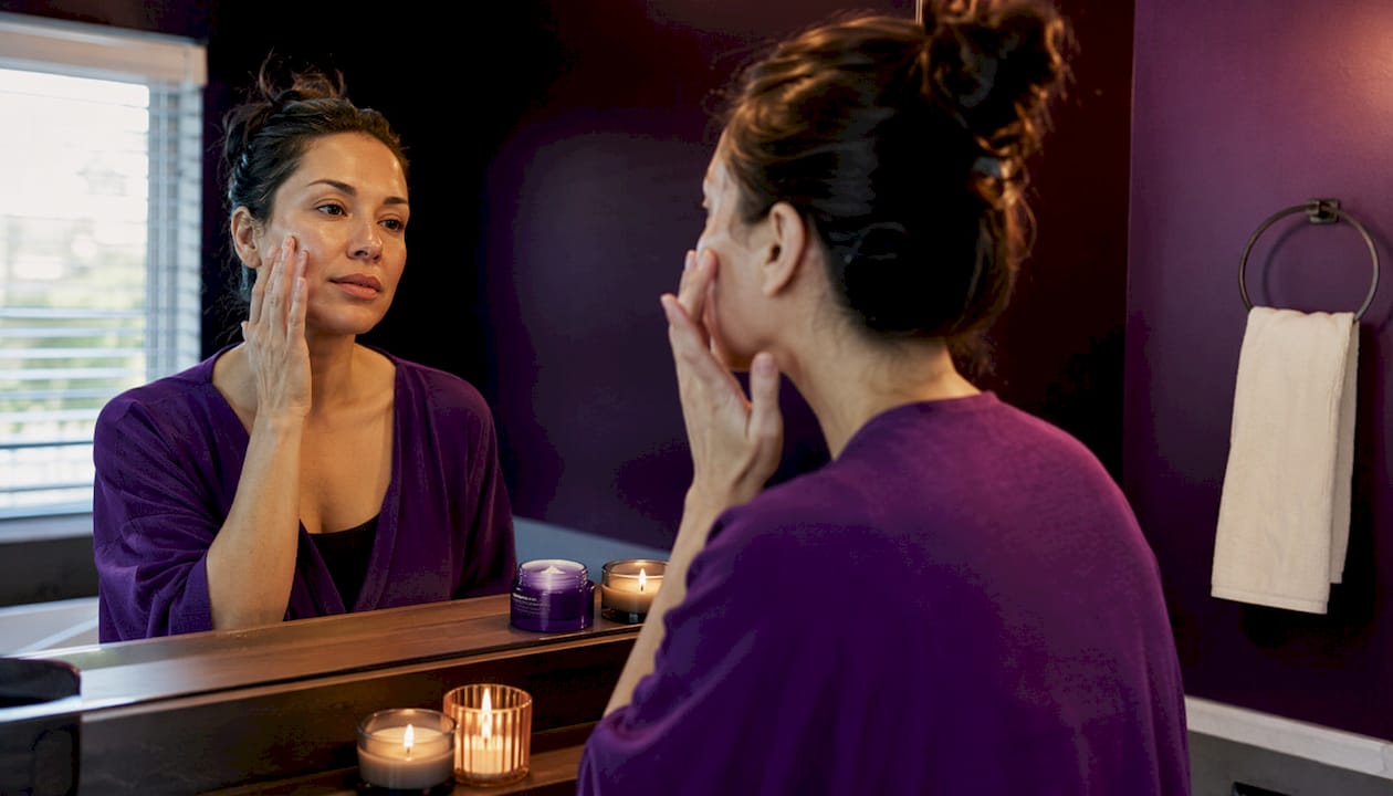 Woman patting Korean essence into skin