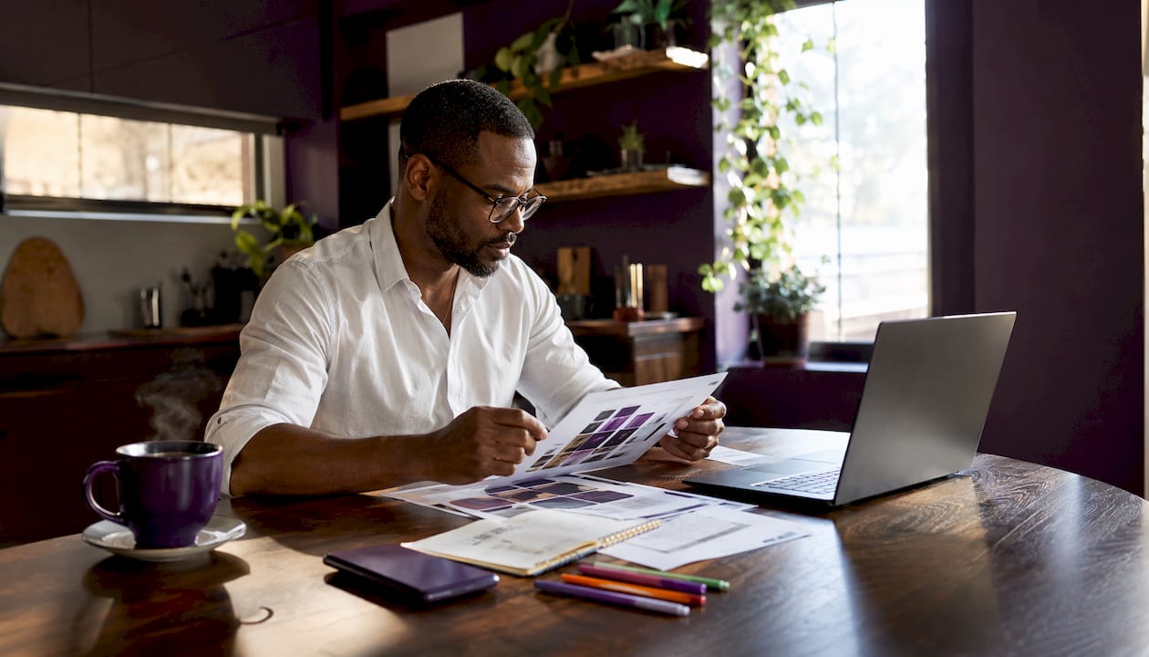 Man comparing skincare product charts at desk