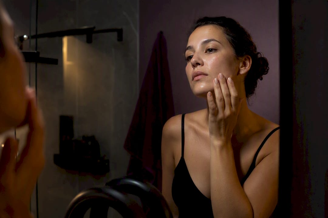 Person gently patting serum on face