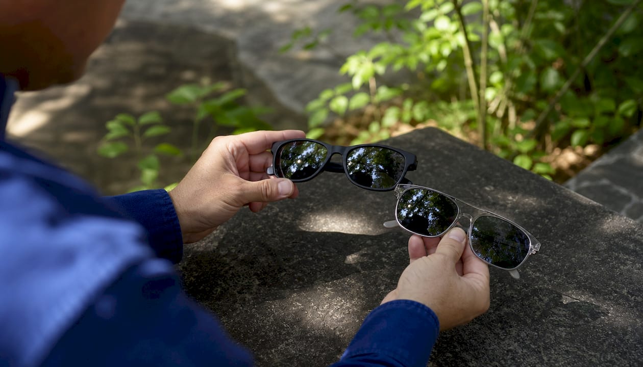 Hands holding two types of affordable sunglasses frames