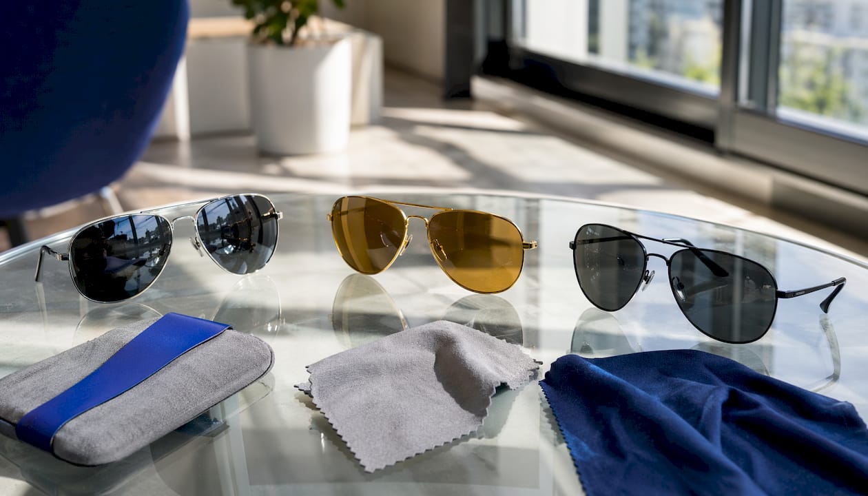 Close-up of aviator sunglasses styles on wooden table