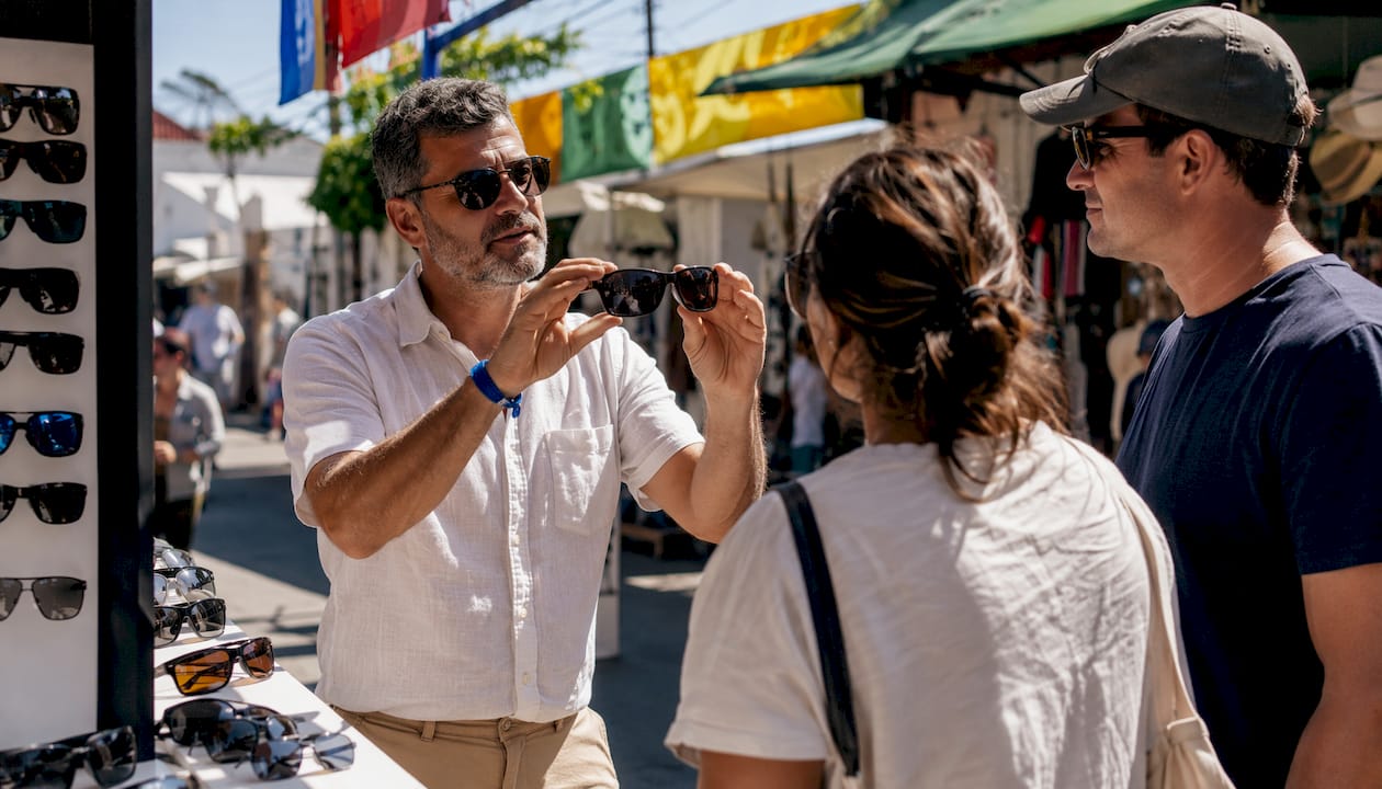 Sales associate showing UV sunglasses features