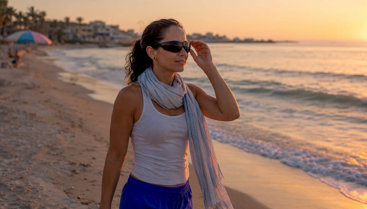 Woman adjusting wrap sunglasses while jogging