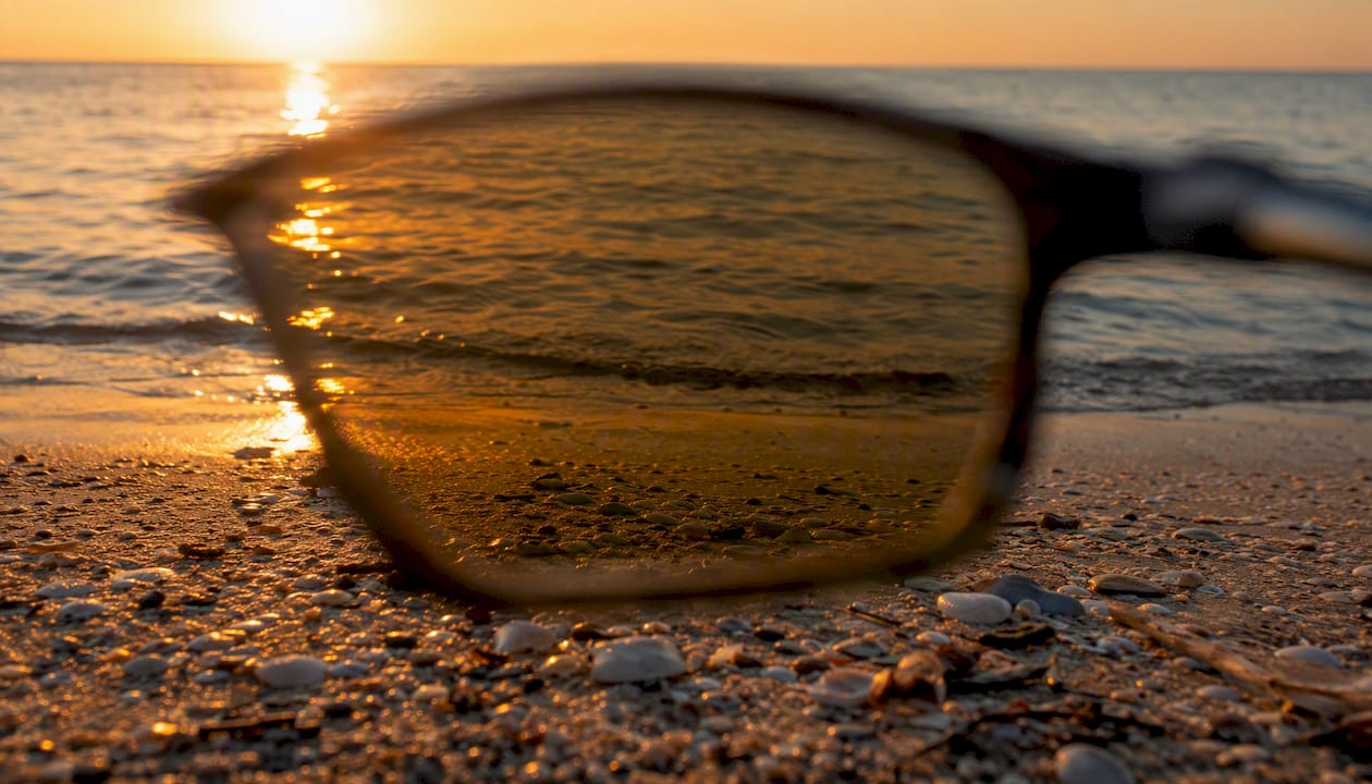 Close-up of polarized lens reducing glare on wet pavement