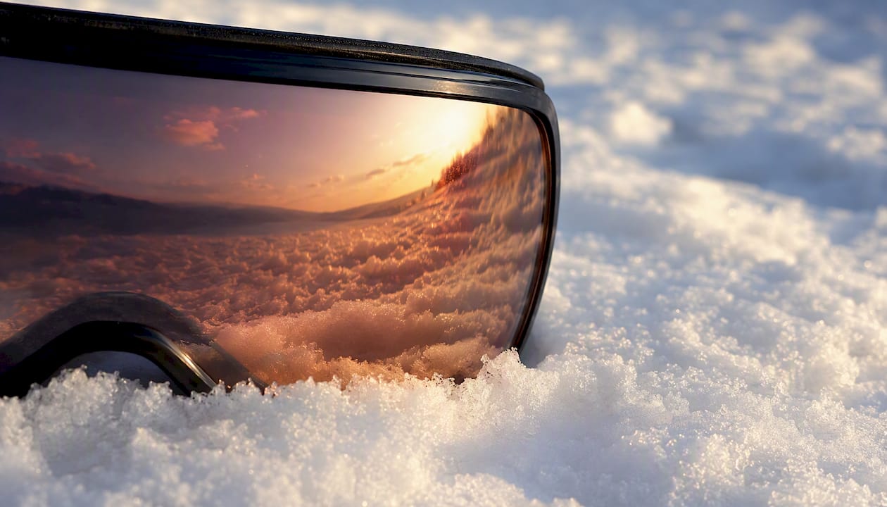 Cylindrical goggle lens curvature close-up on snow