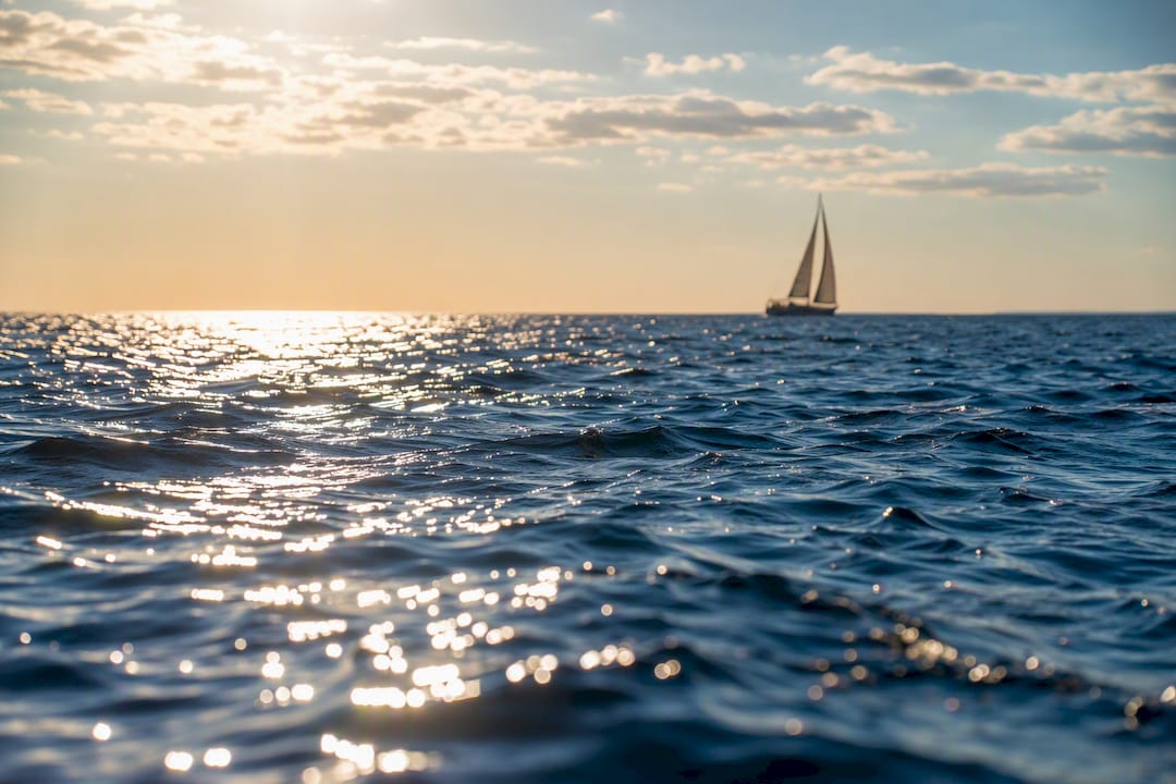 Sunlit glary deep blue ocean surface