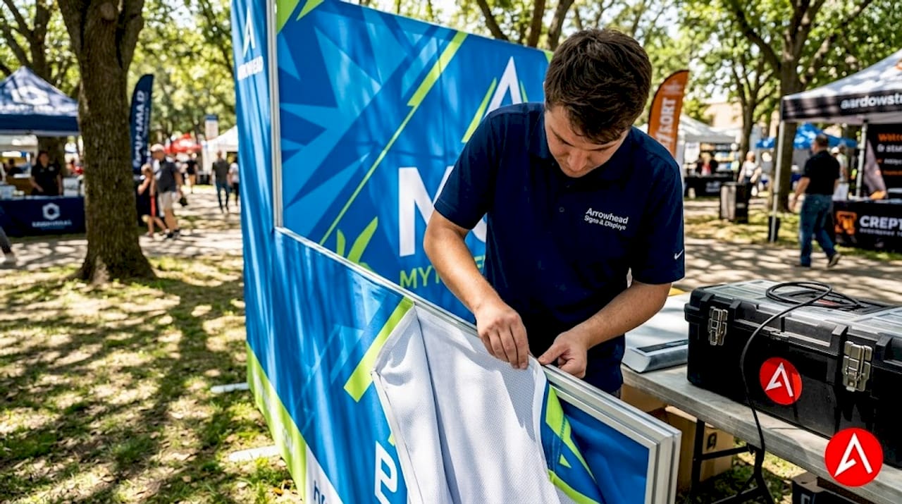 Technician installs fabric tension backdrop