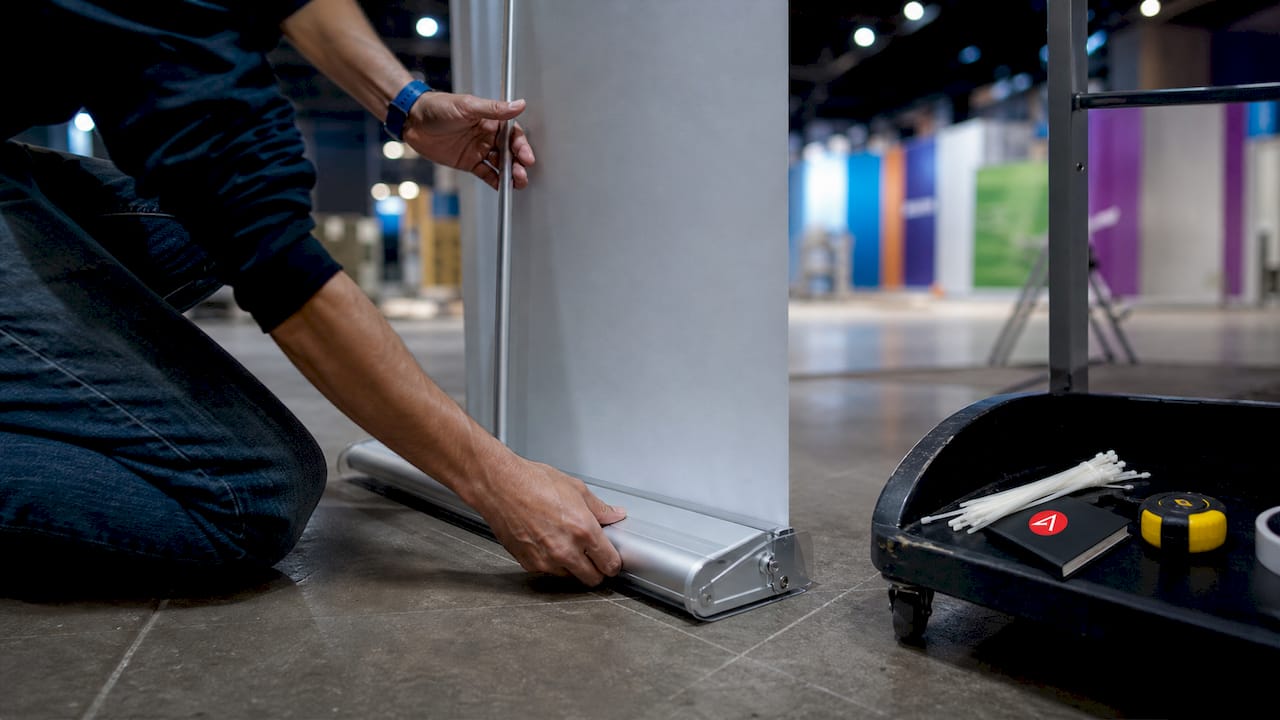 Hands assembling retractable banner stand