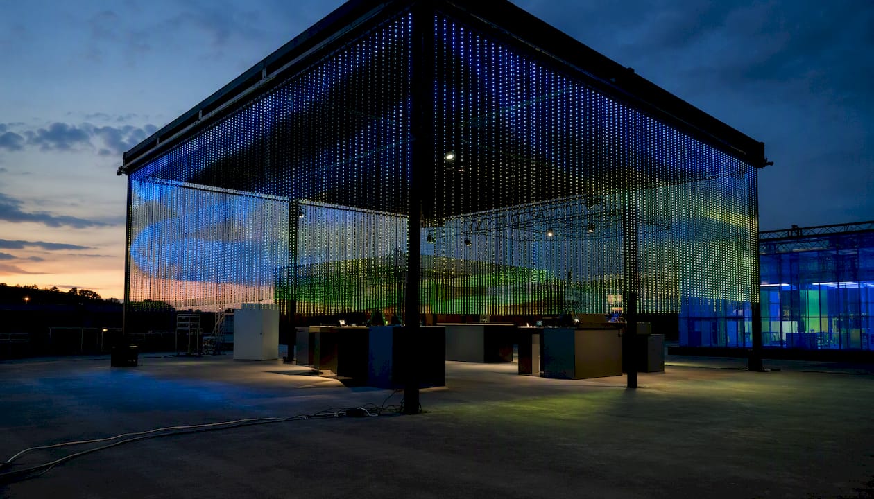 LED mesh curtain panels creating dynamic trade show booth lighting