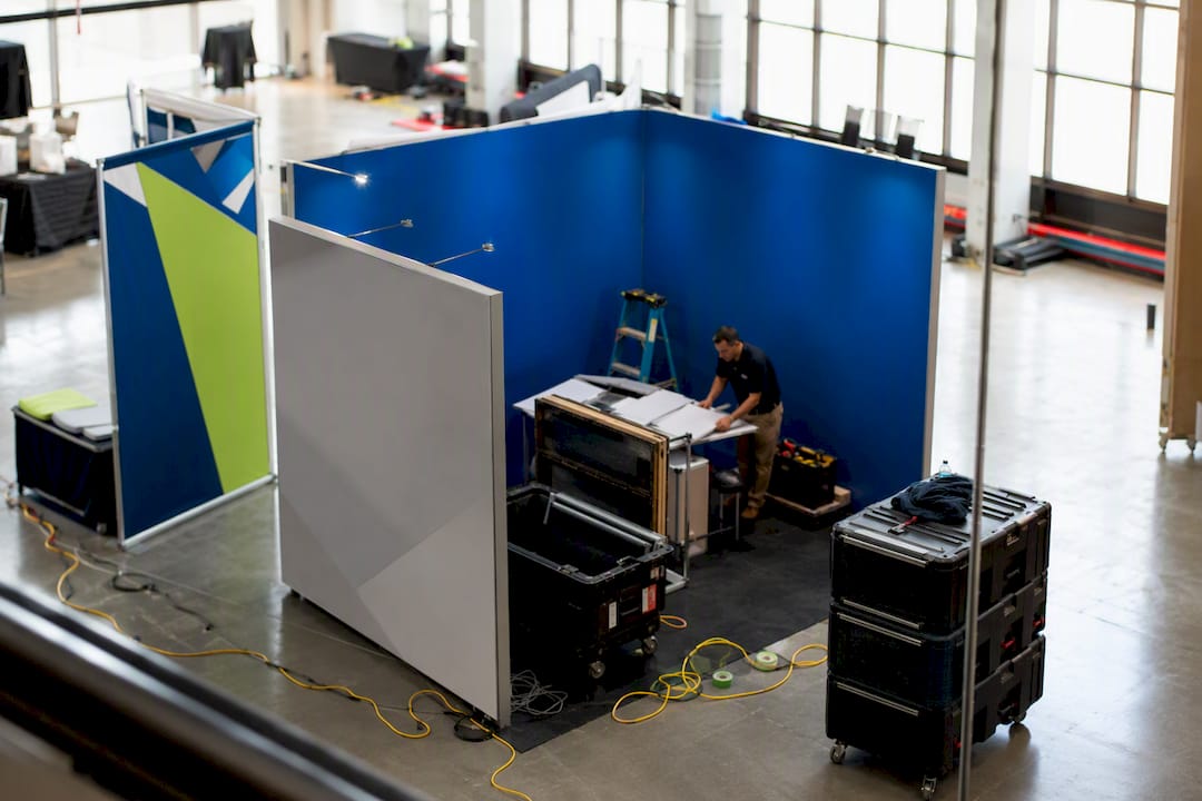 Trade show corner booth space with setup activity