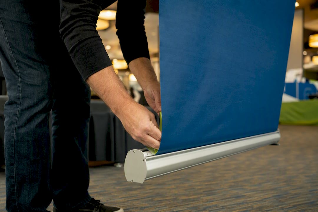 Hands extending retractable banner