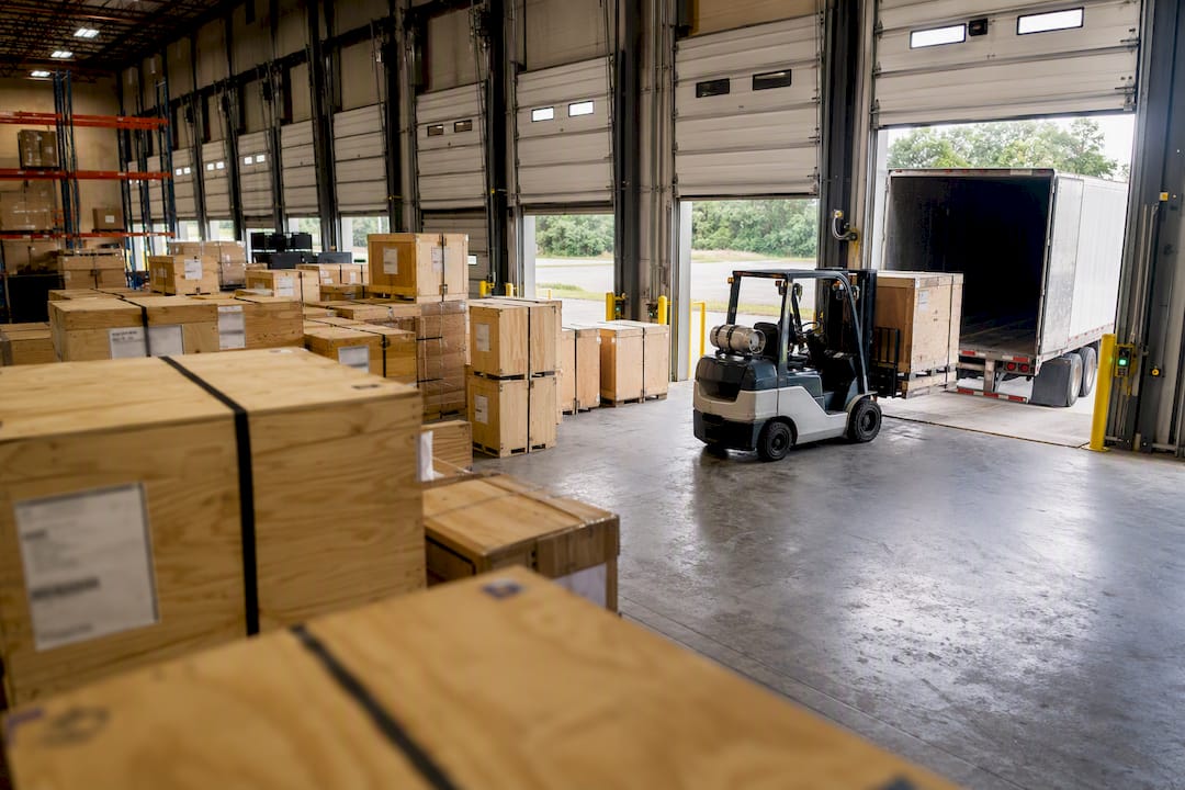 Shipping crates in warehouse with forklift